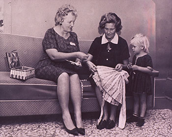 A homemaker from the State Board of Public Welfare in Raleigh, NC, works with a mother on home management and child care skills, c. 1950. (National Library of Medicine)